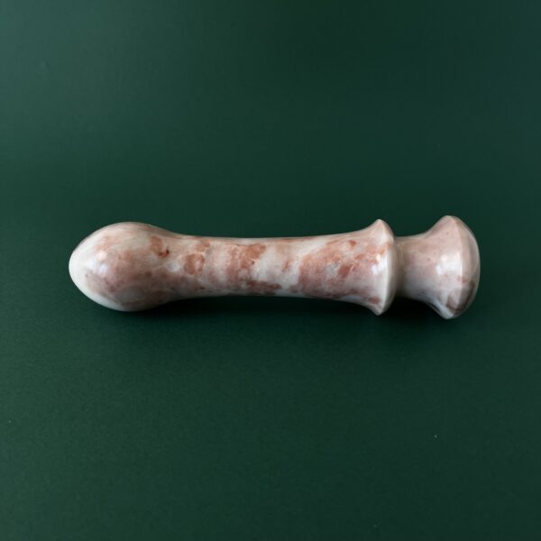 Cherry marble dildo in light — red stone luxury adult toy photography