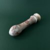 Cherry marble dildo tip close up — handcrafted red marble sex toy