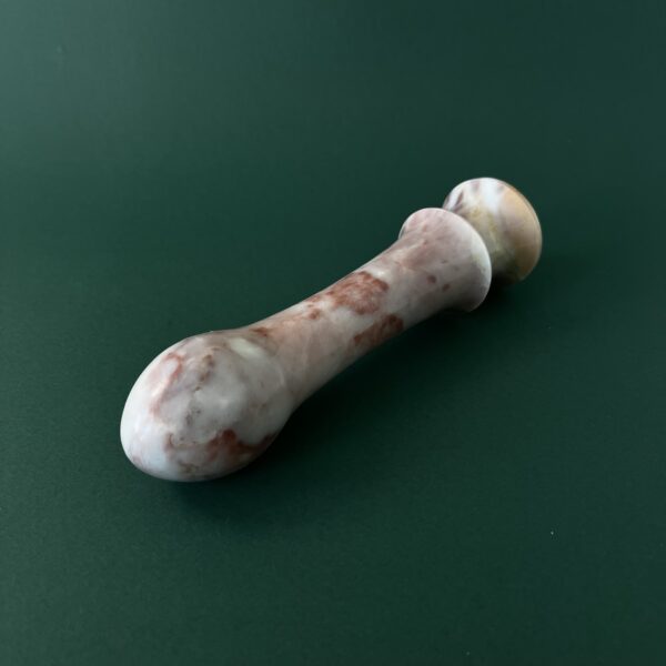 Cherry marble dildo tip close up — handcrafted red marble sex toy