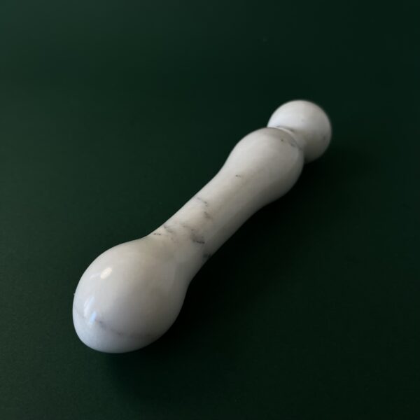 White marble stone dildo lifestyle image — luxury adult toy photography