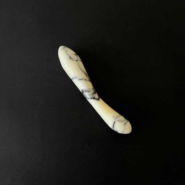 White marble g-spot stimulator studio photography — luxury stone intimate toy